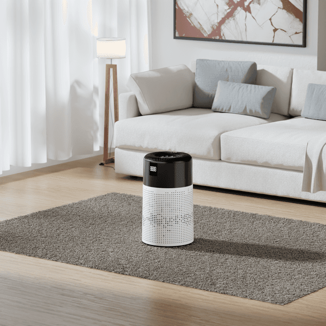 Cylindrical air purifier standing on a rug in a bright living room